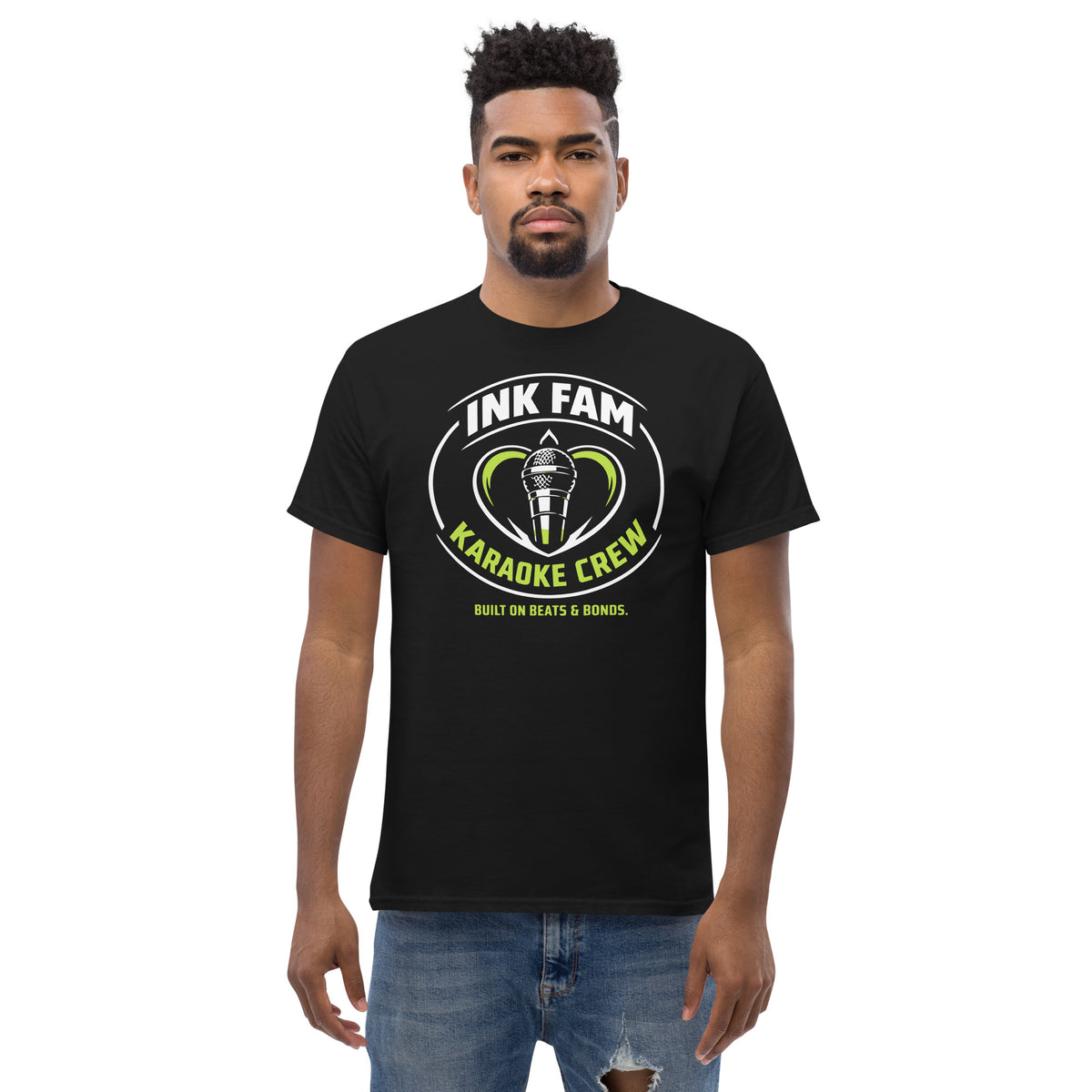 Black classic T-shirt, front view, featuring DJ Ink Fam green-and-white circular microphone badge.