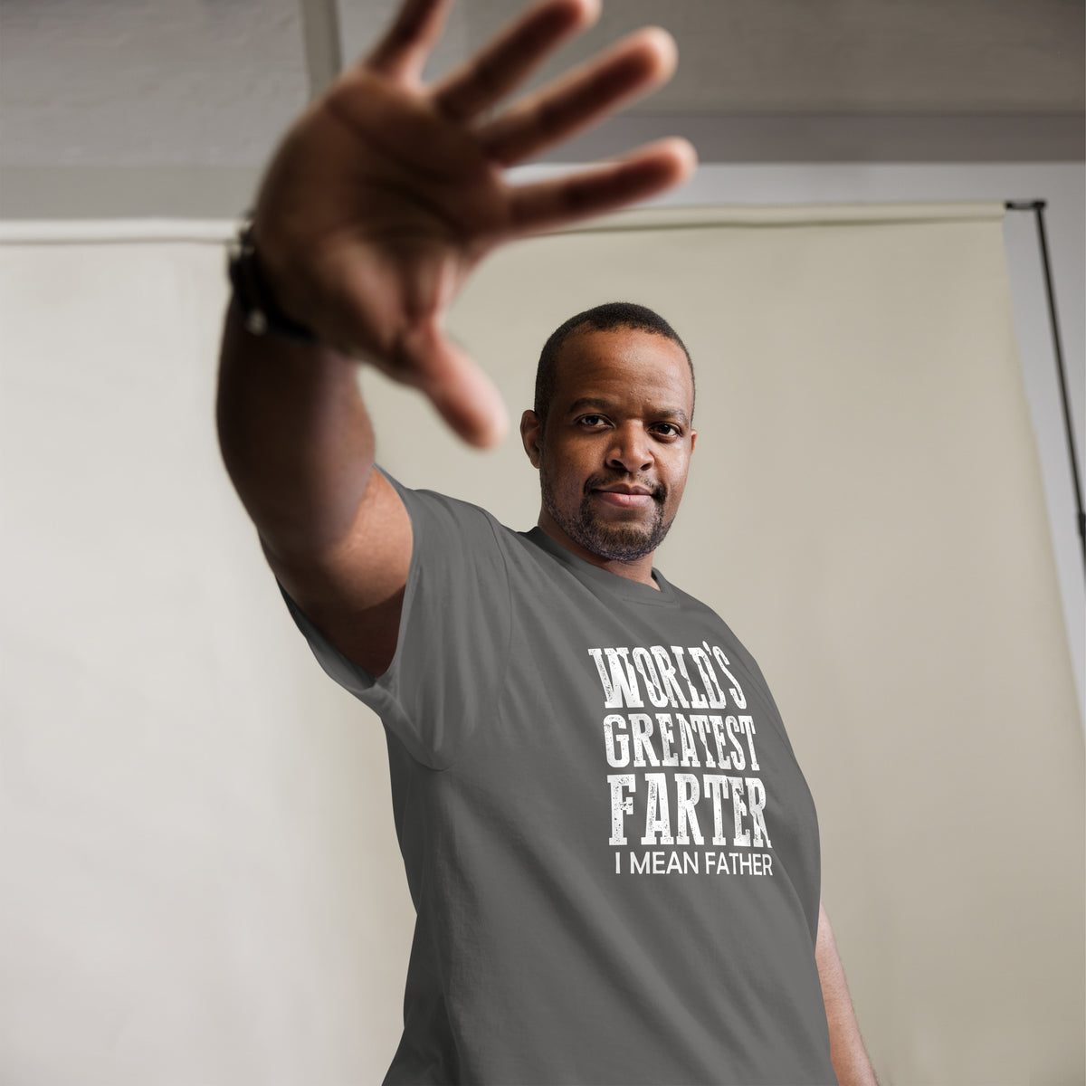 Charcoal classic T-shirt, alternate front mockup, featuring white World's Greatest Farter, I Mean Father lettering.