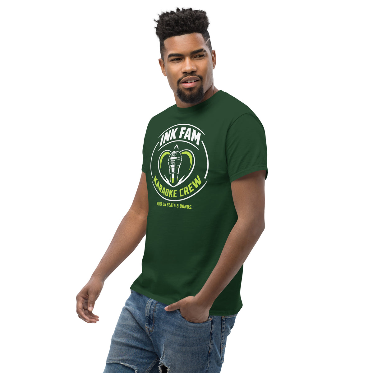 Forest Green classic T-shirt, left-front angled view, featuring DJ Ink Fam green-and-white circular microphone badge.