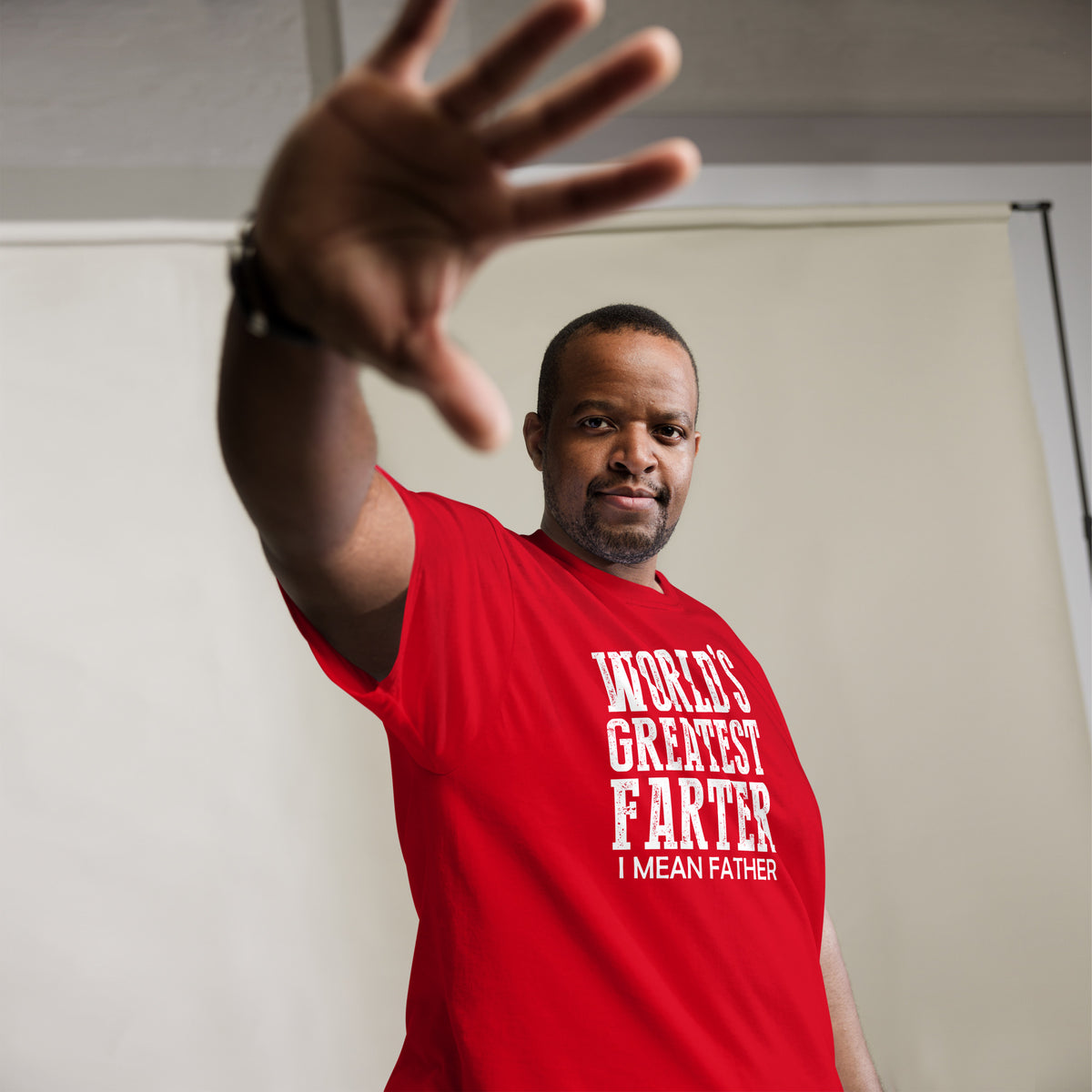 Red classic T-shirt, alternate front mockup, featuring white World's Greatest Farter, I Mean Father lettering.