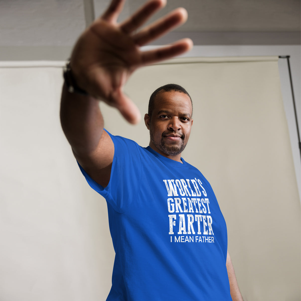 Royal classic T-shirt, alternate front mockup, featuring white World's Greatest Farter, I Mean Father lettering.