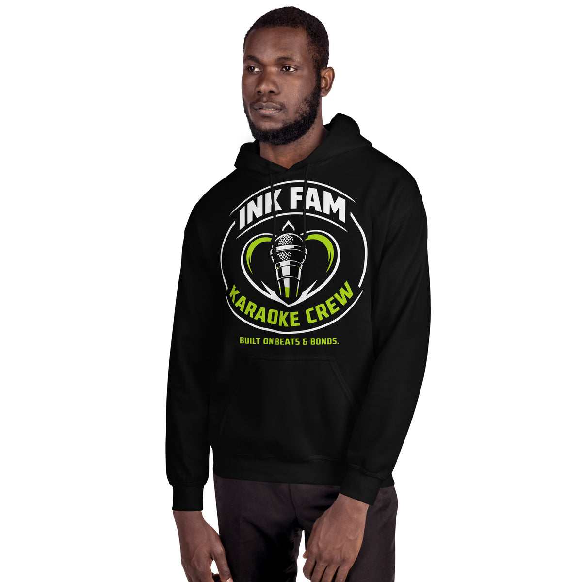 Black pullover hoodie, alternate front mockup, featuring the green-and-white circular DJ Ink Fam microphone badge.