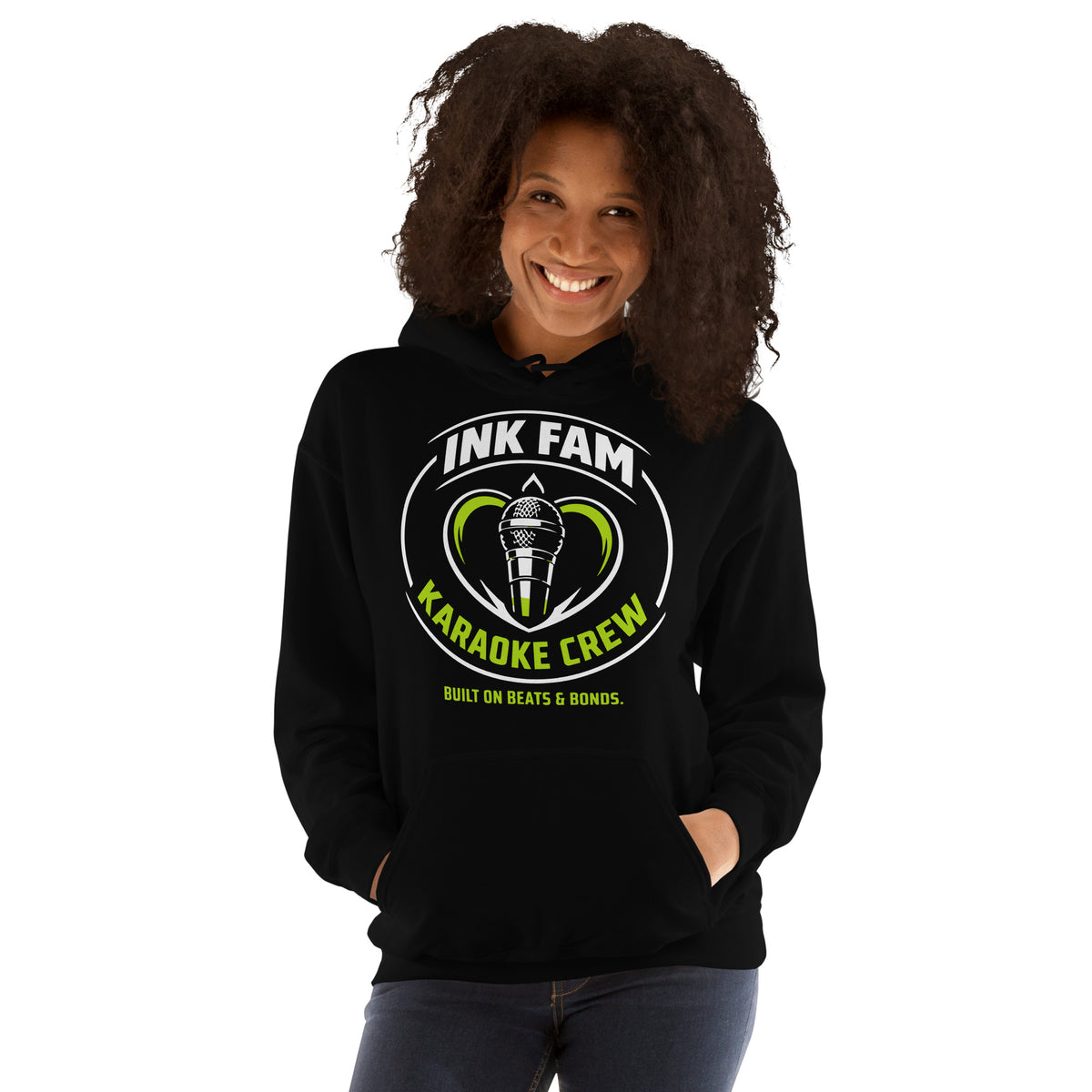 Black pullover hoodie, front view, featuring the green-and-white circular DJ Ink Fam microphone badge.