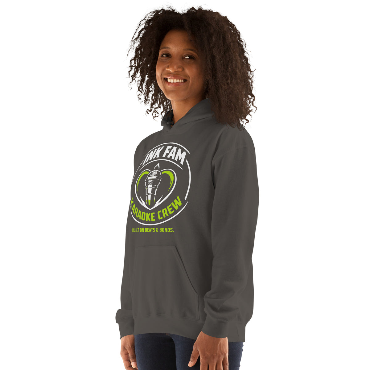 Charcoal pullover hoodie, left-front angled view, featuring the green-and-white circular DJ Ink Fam microphone badge.