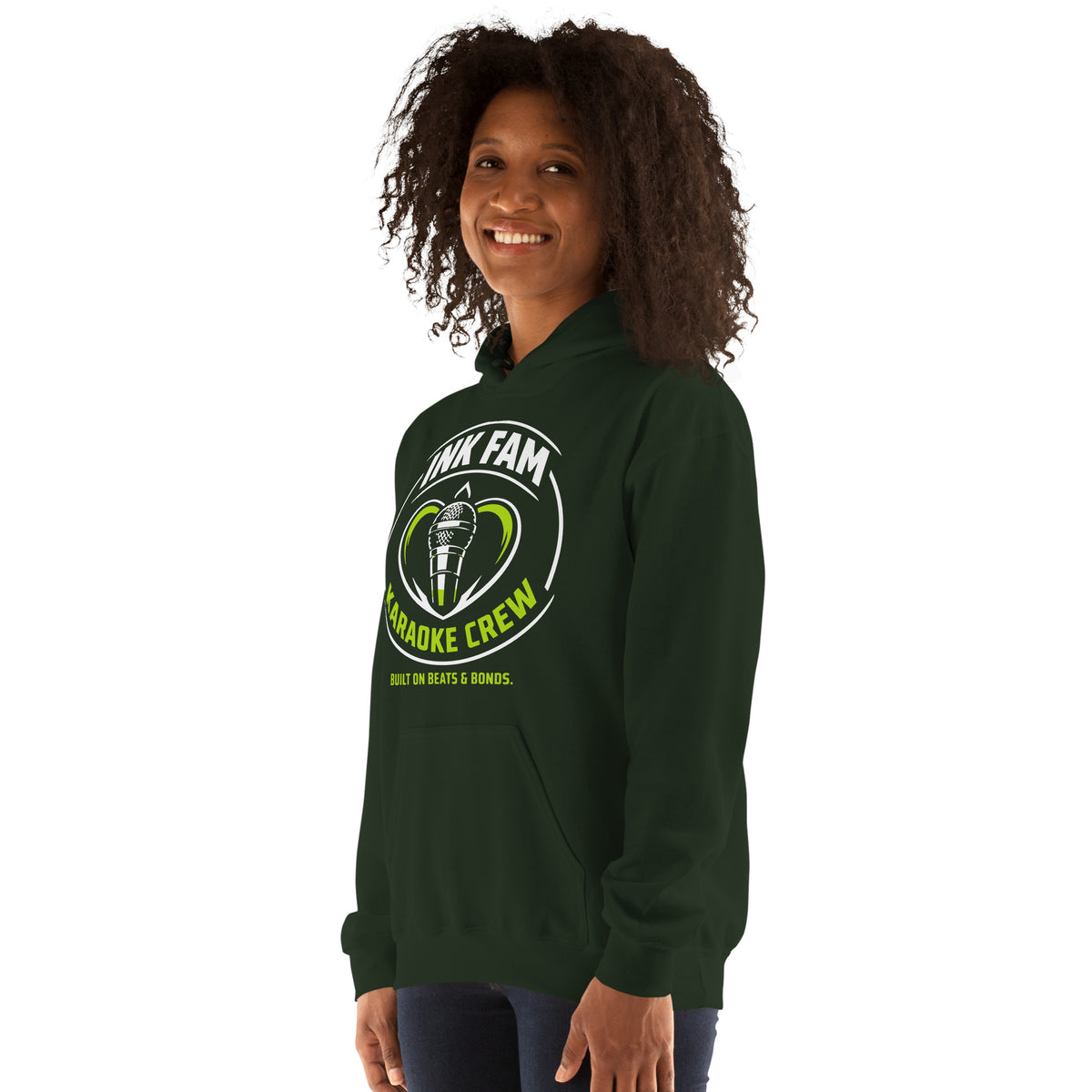 Forest Green pullover hoodie, left-front angled view, featuring the green-and-white circular DJ Ink Fam microphone badge.