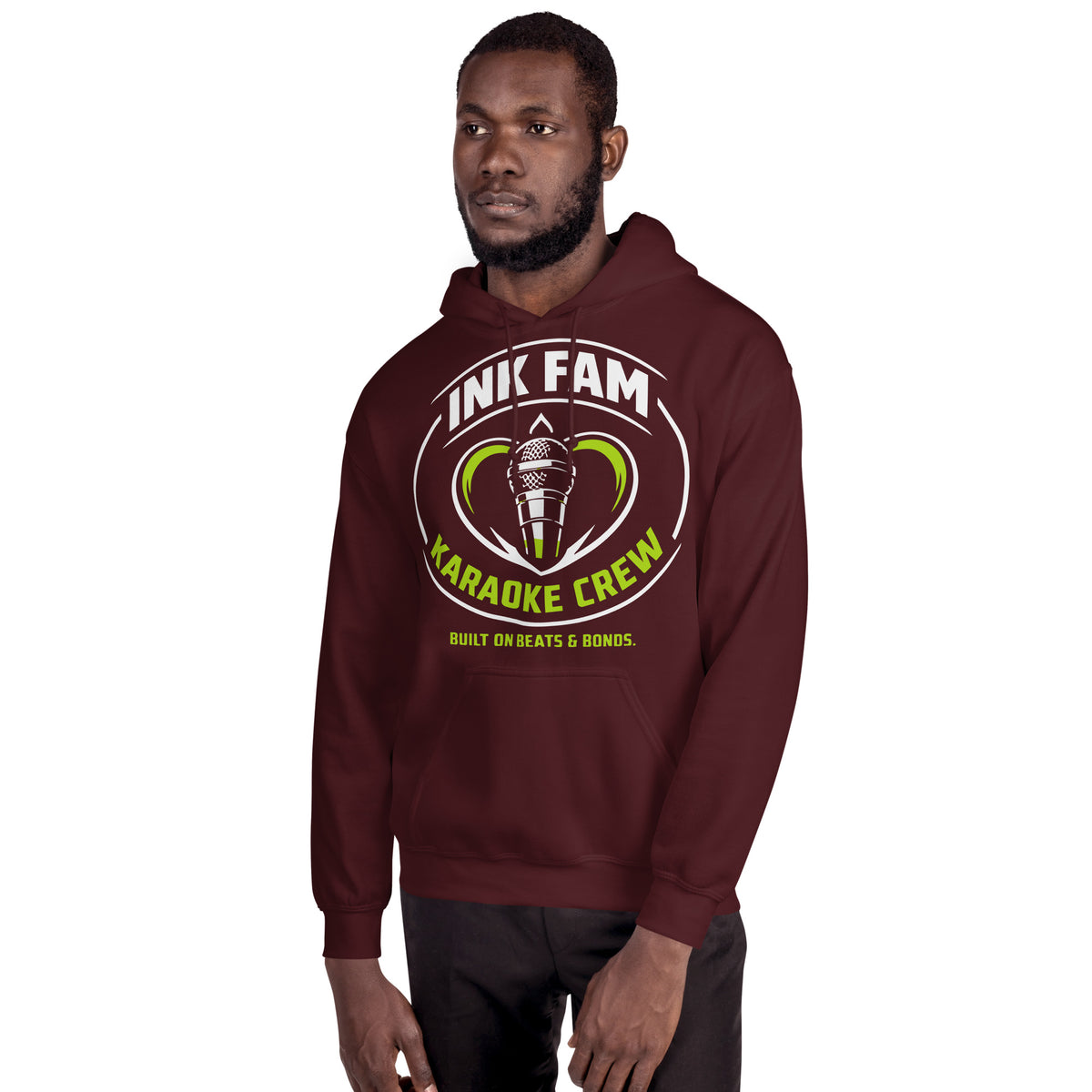 Maroon pullover hoodie, alternate front mockup, featuring the green-and-white circular DJ Ink Fam microphone badge.