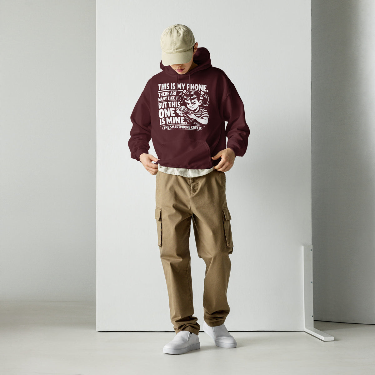 Maroon pullover hoodie, front view, showing a mockup for Smartphone Creed retro woman holding a phone and statement lettering.