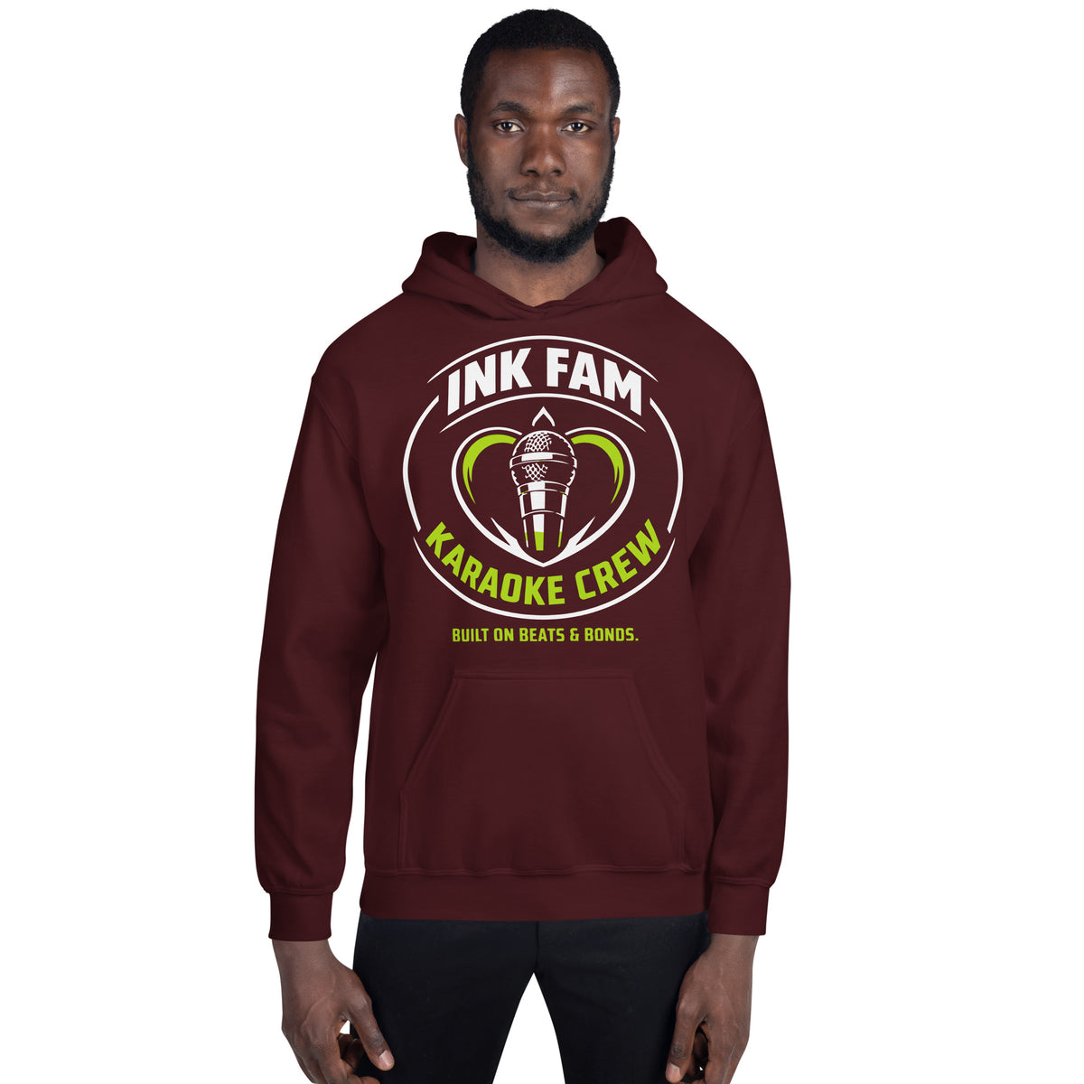 Maroon pullover hoodie, front view, featuring the green-and-white circular DJ Ink Fam microphone badge.