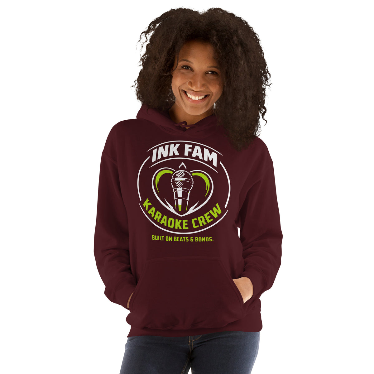 Maroon pullover hoodie, front view, featuring the green-and-white circular DJ Ink Fam microphone badge.