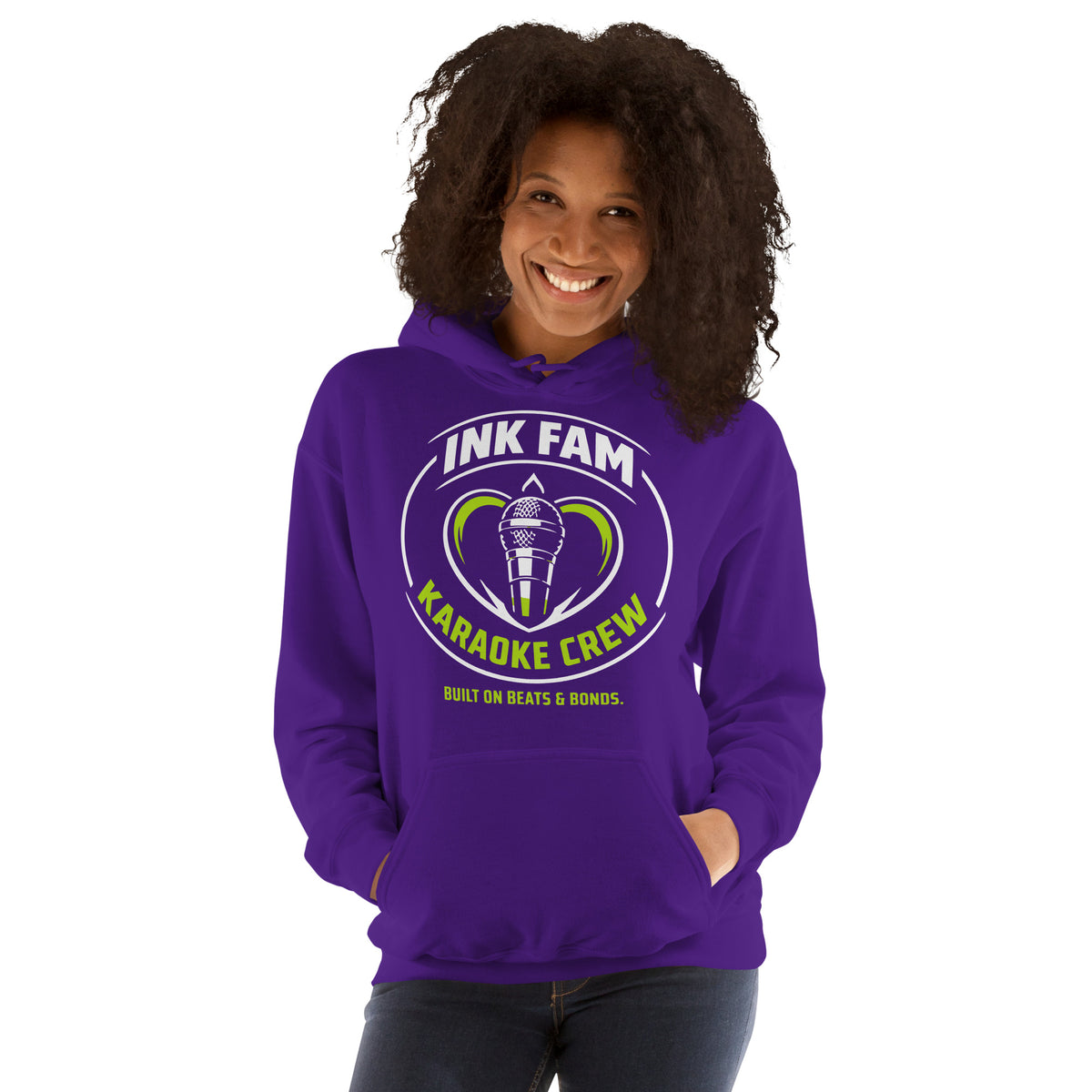 Purple pullover hoodie, front view, featuring the green-and-white circular DJ Ink Fam microphone badge.