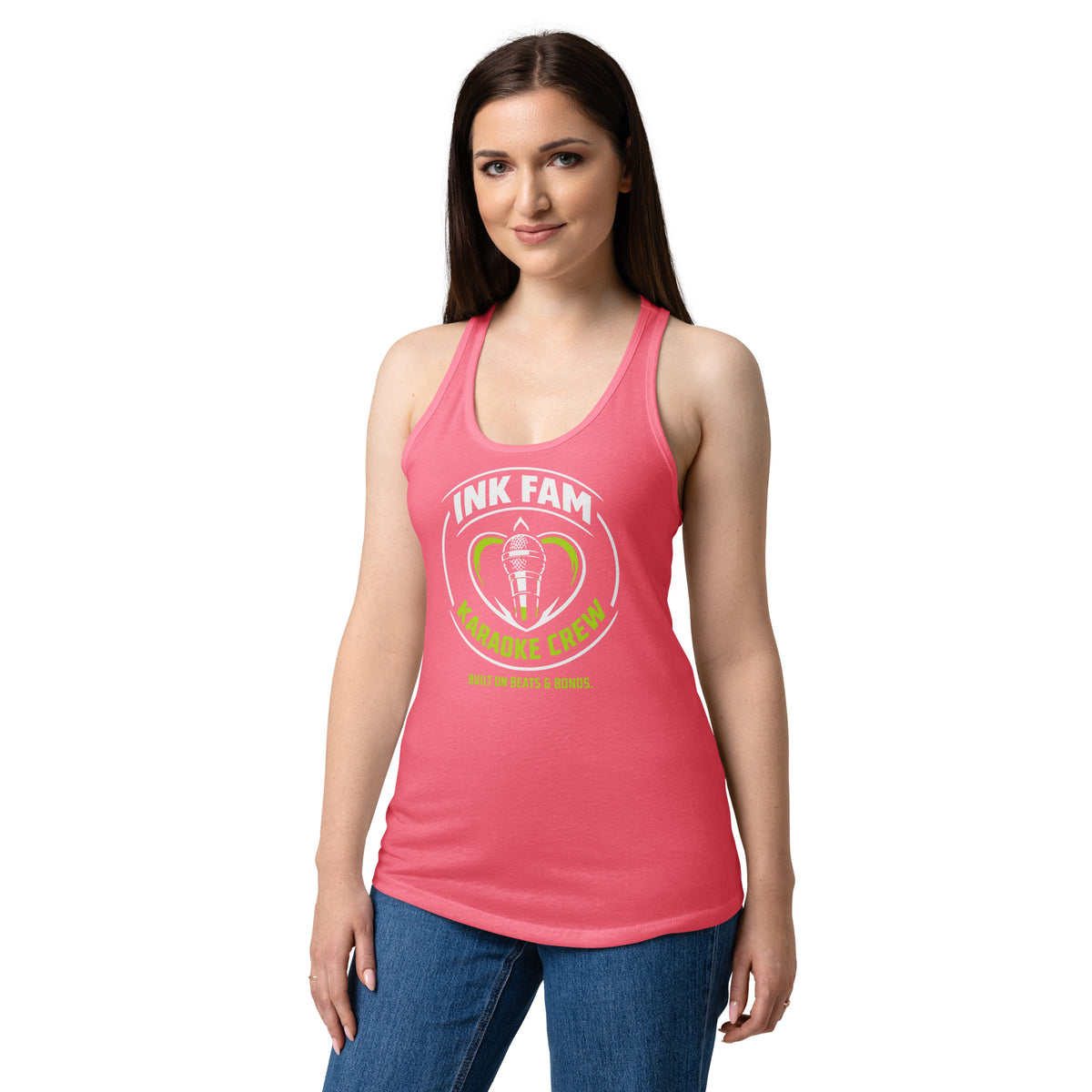 Hot Pink women's racerback tank top, front view, featuring DJ Ink Fam green-and-white circular microphone badge.