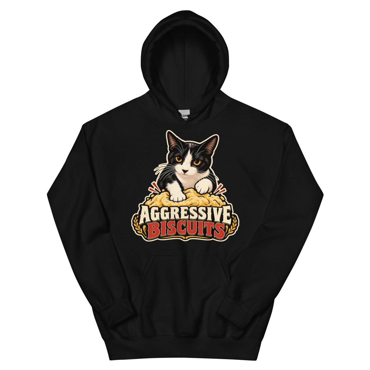 Black pullover hoodie, front view, featuring a black and white tuxedo cat with amber eyes kneading a mound of golden dough, under vintage bakery badge lettering reading Aggressive Biscuits