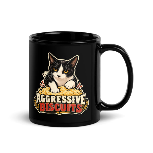 Black glossy mug, 11 oz, handle on right view, featuring a black and white tuxedo cat with amber eyes kneading a mound of golden dough, under vintage bakery badge lettering reading Aggressive Biscuits