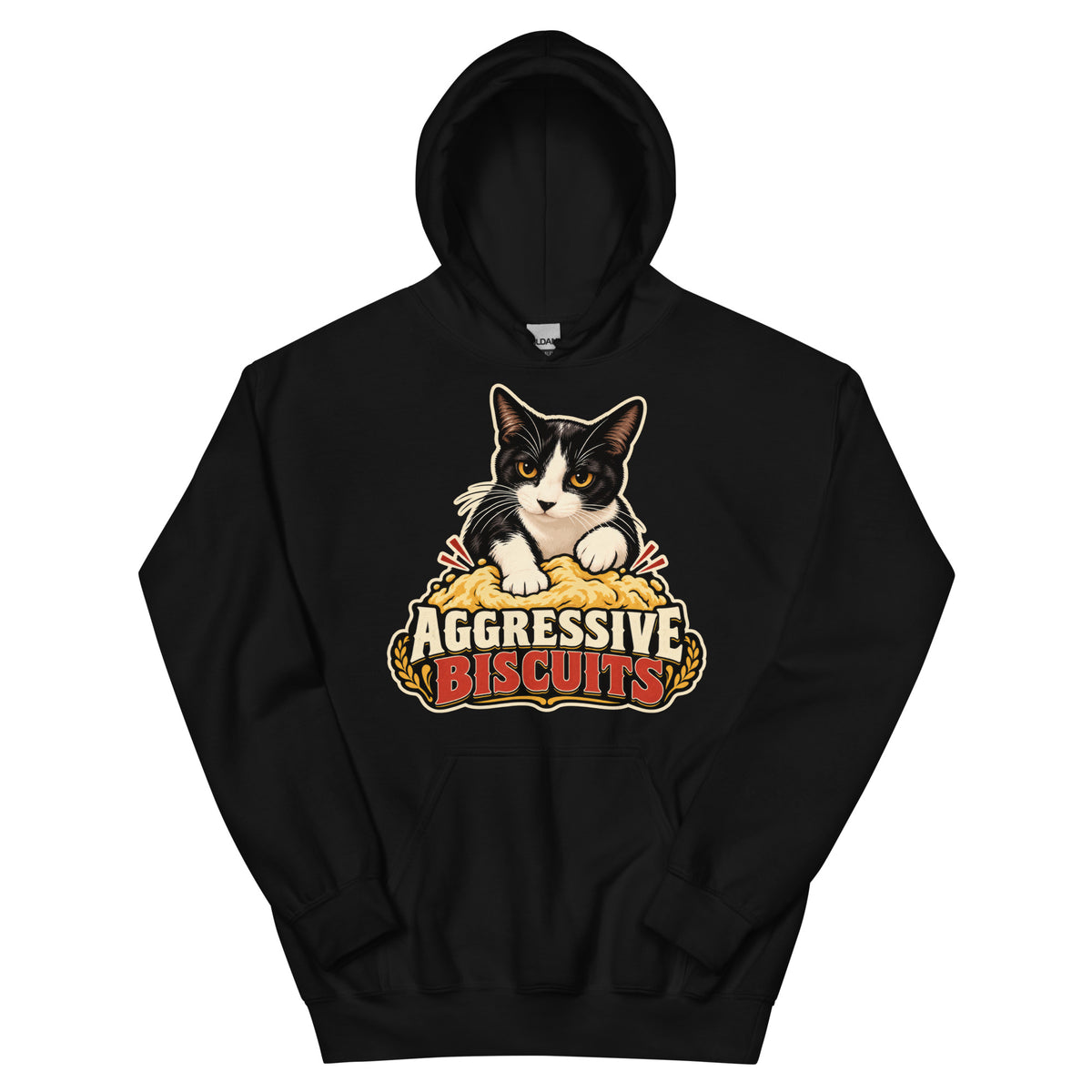Black pullover hoodie, front view, featuring a black and white tuxedo cat with amber eyes kneading a mound of golden dough, under vintage bakery badge lettering reading Aggressive Biscuits