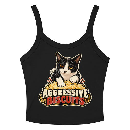 Solid Black Blend women's micro-rib tank top, front view, featuring a black and white tuxedo cat with amber eyes kneading a mound of golden dough, under vintage bakery badge lettering reading Aggressive Biscuits